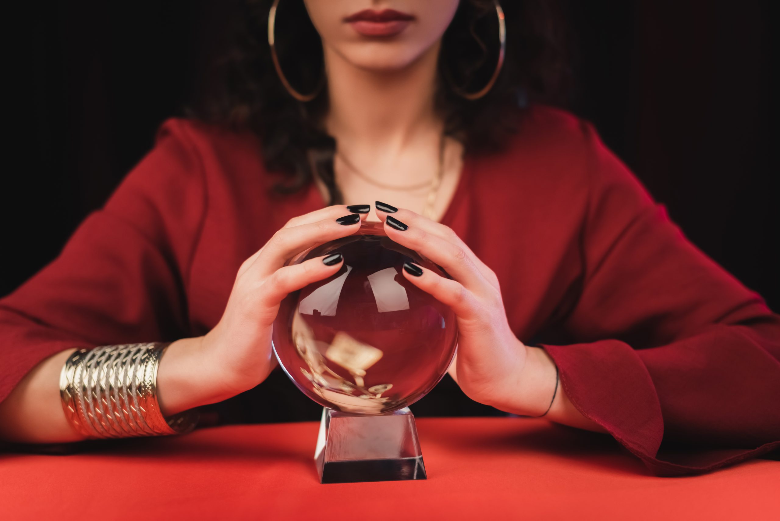 Person with hands on a crystal ball.